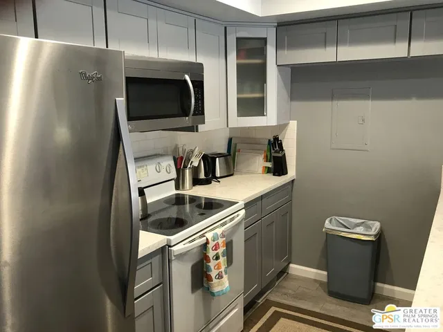 a kitchen with stainless steel appliances granite countertop a sink and a microwave