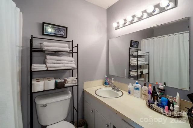 a bathroom with a toilet sink and mirror