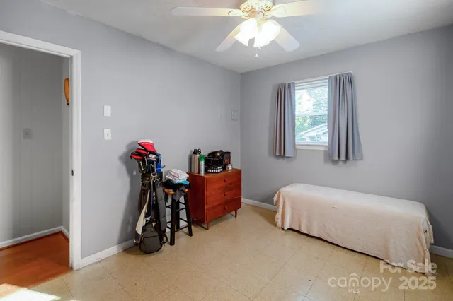 a bedroom with bed and a chandelier