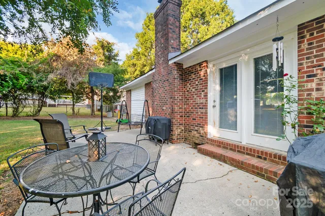 a backyard of a house with outdoor seating