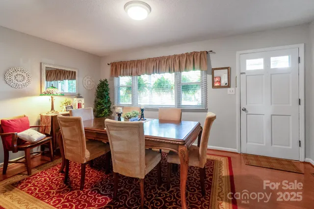 a view of a dining room with furniture window and outside view