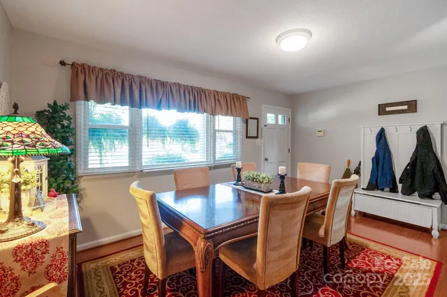 a dining room with furniture and window