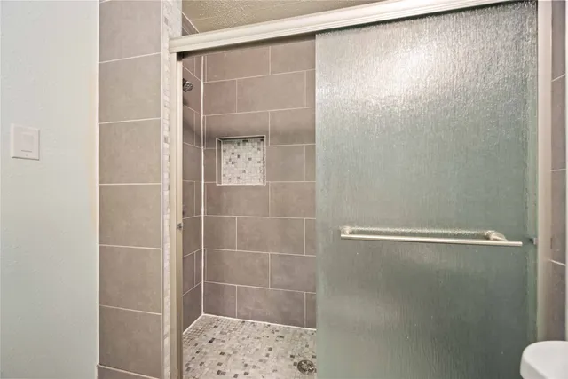 a bathroom with a glass shower door