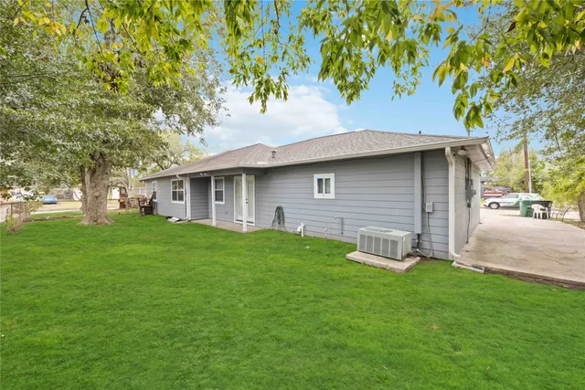 a front view of a house with a garden and yard
