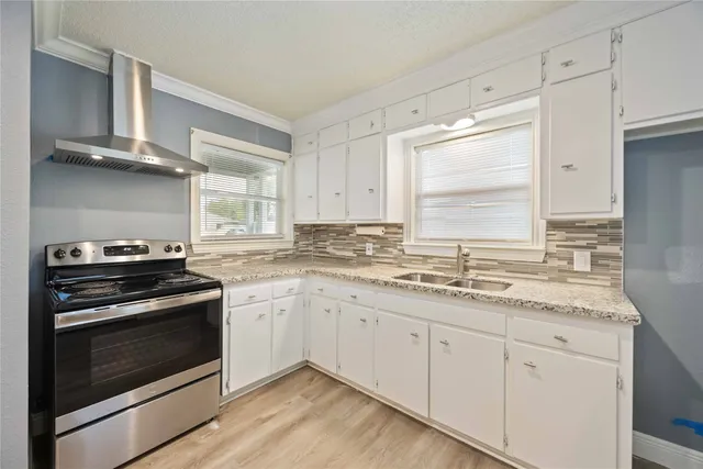 a kitchen with granite countertop cabinets stainless steel appliances and a sink