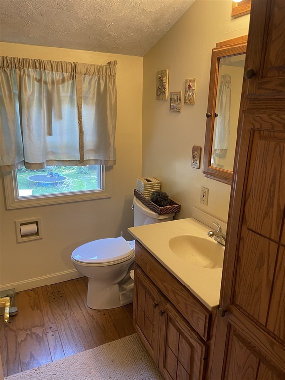 75 Lexington Road Billerica, MA 01821 - Photo 15 of 25 a bathroom with a granite countertop toilet sink and mirror