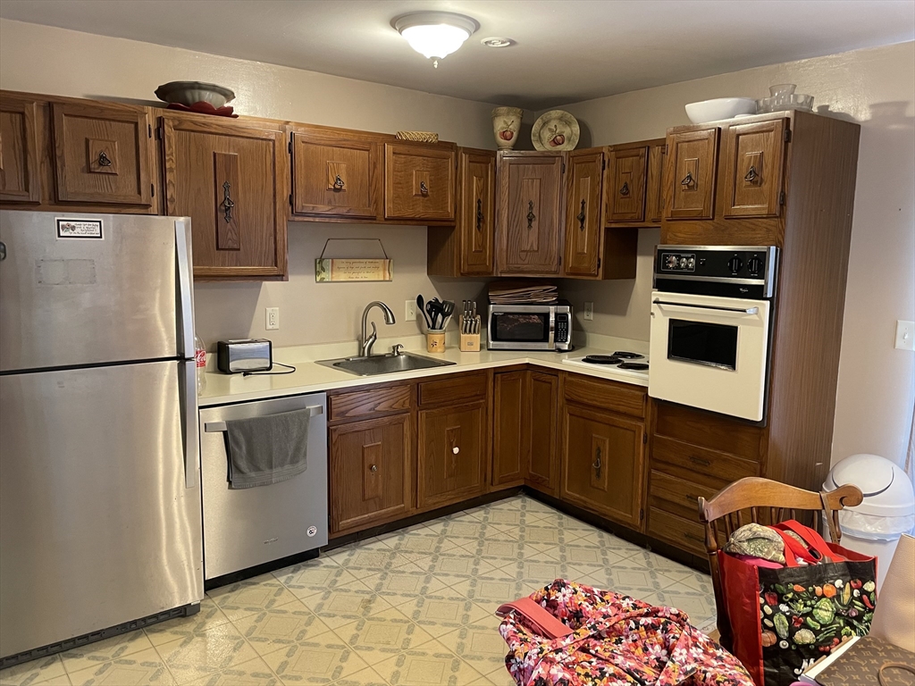 75 Lexington Road Billerica, MA 01821 - Photo 17 of 25 a kitchen with stainless steel appliances granite countertop a refrigerator and a stove top oven