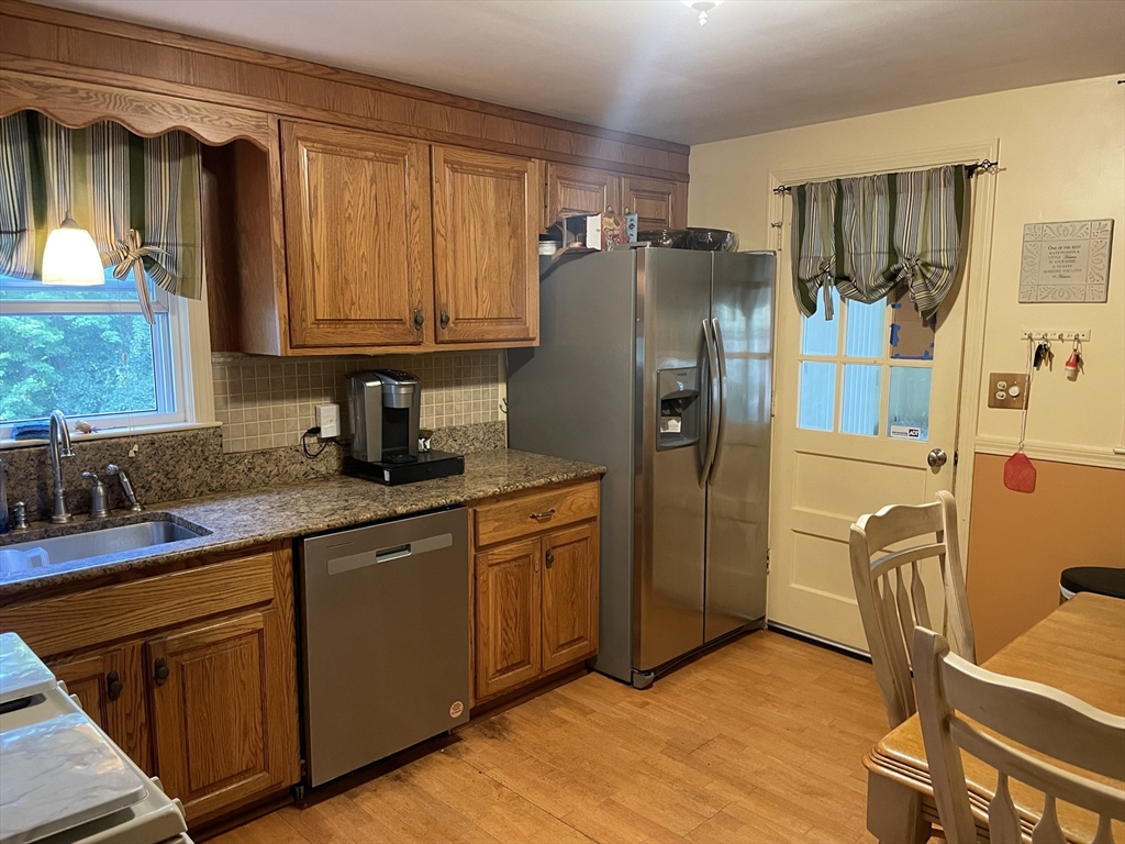 75 Lexington Road Billerica, MA 01821 - Photo 4 of 25 a kitchen with stainless steel appliances granite countertop a refrigerator and a sink