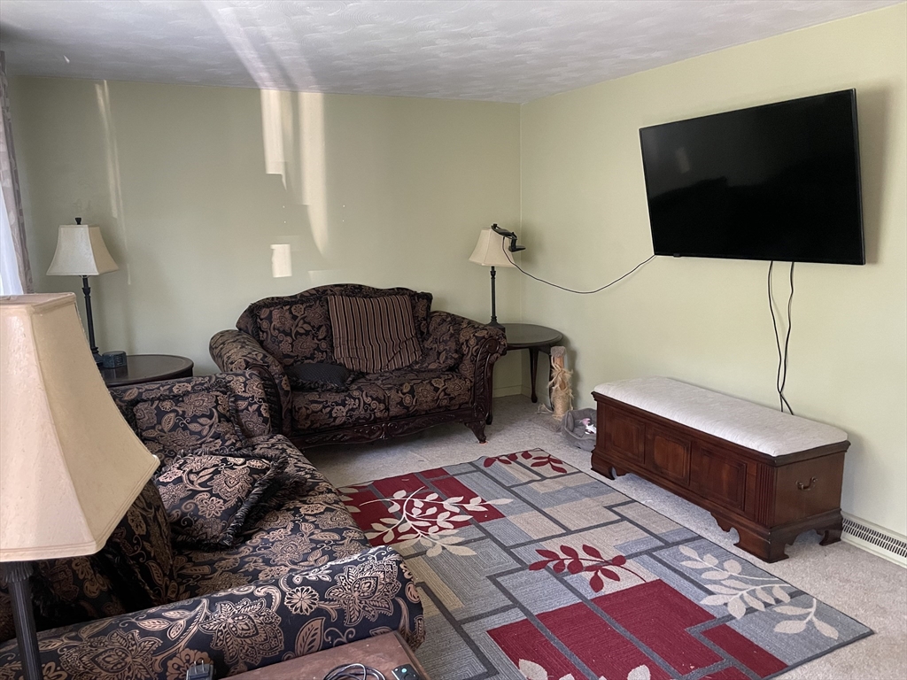 75 Lexington Road Billerica, MA 01821 - Photo 8 of 25 a living room with furniture and a flat screen tv