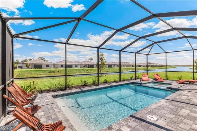 a view of a backyard with swimming pool