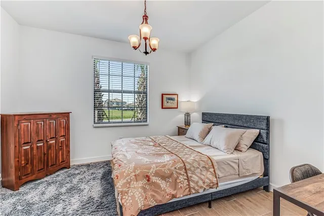 a bedroom with a large bed and a window