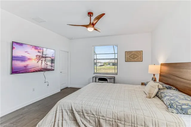 a bedroom with a bed and a painting on the wall