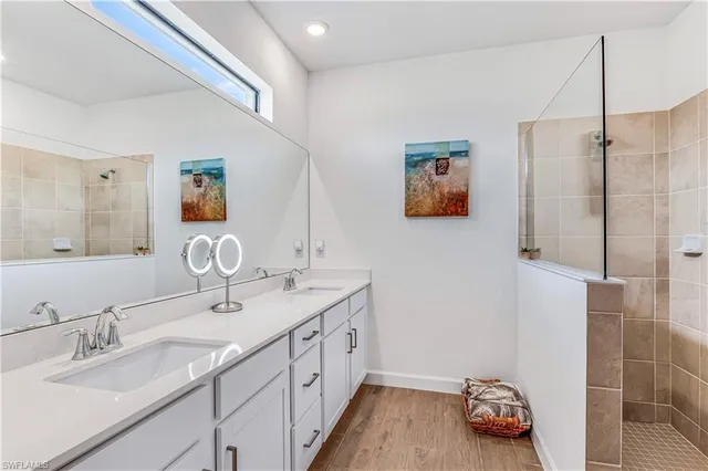 a bathroom with a double vanity sink and a mirror