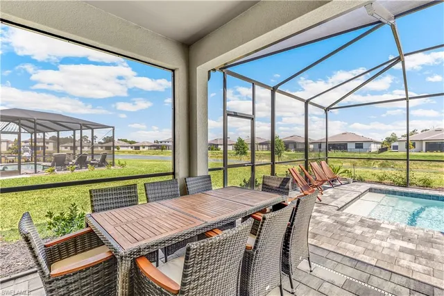 a view of a patio with a table chairs and balcony