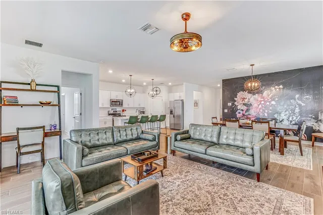 a living room with furniture and a chandelier