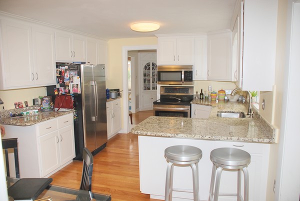 37 Webster Road Lexington, MA 02421 - Photo 6 of 11 a kitchen with stainless steel appliances granite countertop a sink refrigerator and cabinets