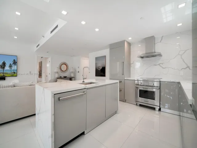 a kitchen with a sink and a stove top oven