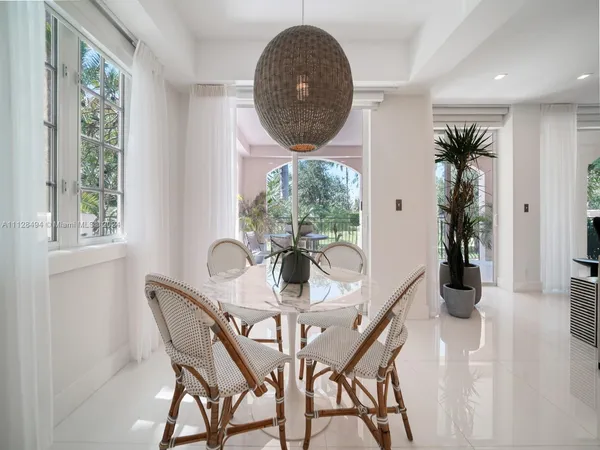 a view of a dining room with furniture and window