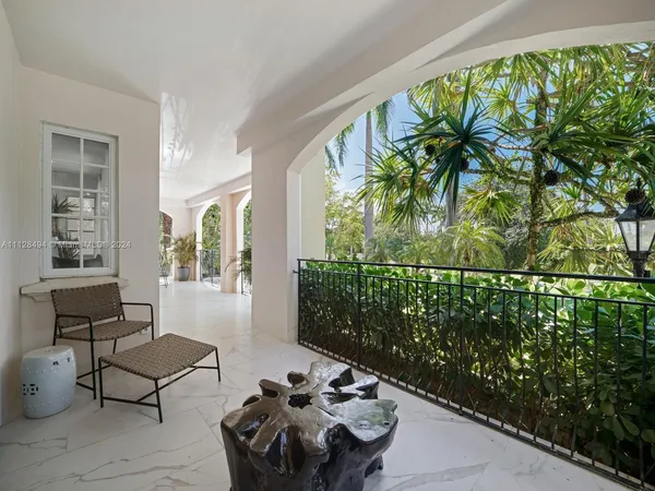 a building outdoor space with patio furniture and potted plants