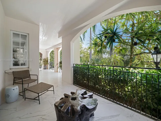 a building outdoor space with patio furniture and potted plants