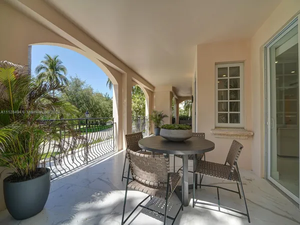 a table and chairs in a balcony