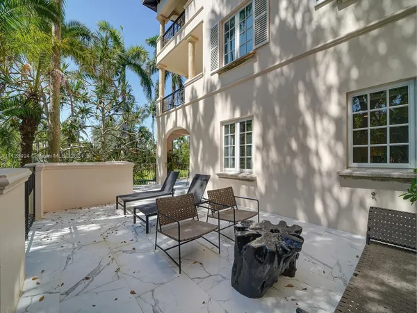 a view of a chairs and table in the patio