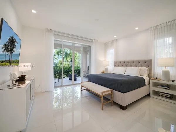 a bedroom with furniture and a flat screen tv