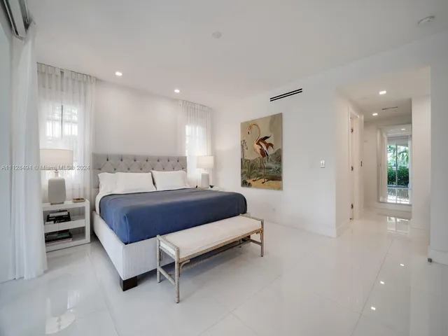 a bathroom with a double vanity sink a mirror and a bathtub