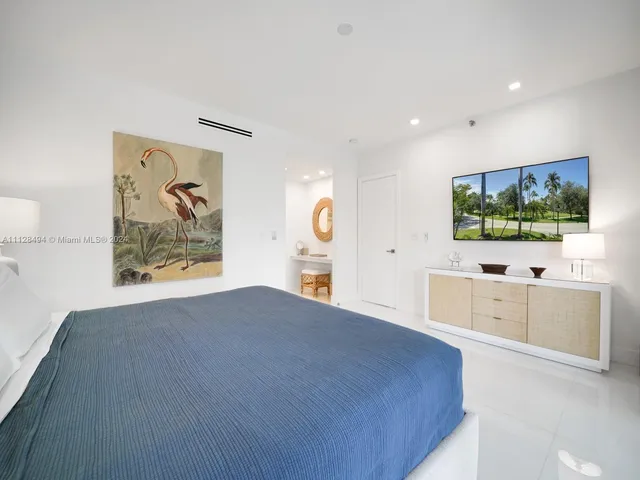 a white bath tub sitting in a bathroom and mirror