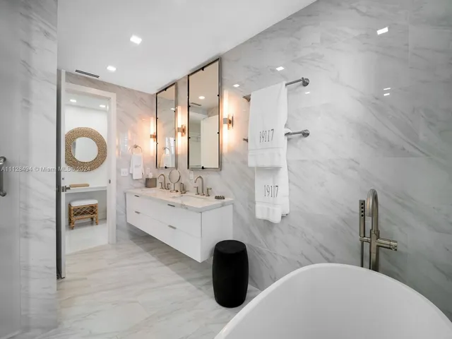 a bathroom with a toilet sink vanity and shower