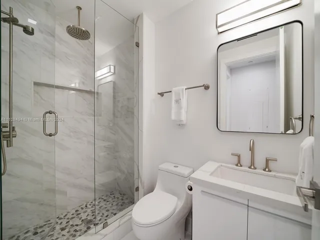 a view of a lake with a floor to ceiling window next to a building