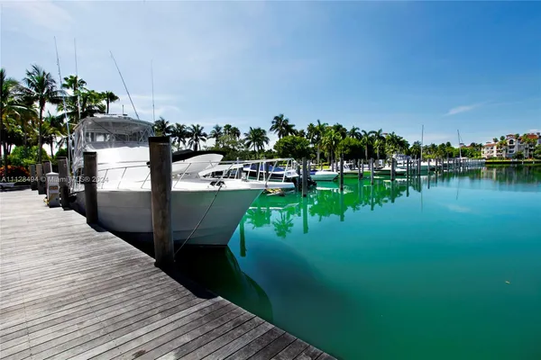 a view of a lake with a house and a big yard