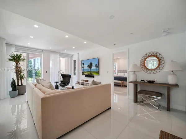 a living room with furniture a window and a clock