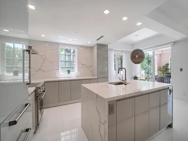 a kitchen with a sink window and cabinets