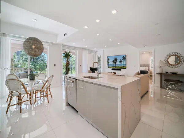 a kitchen with furniture and a large window