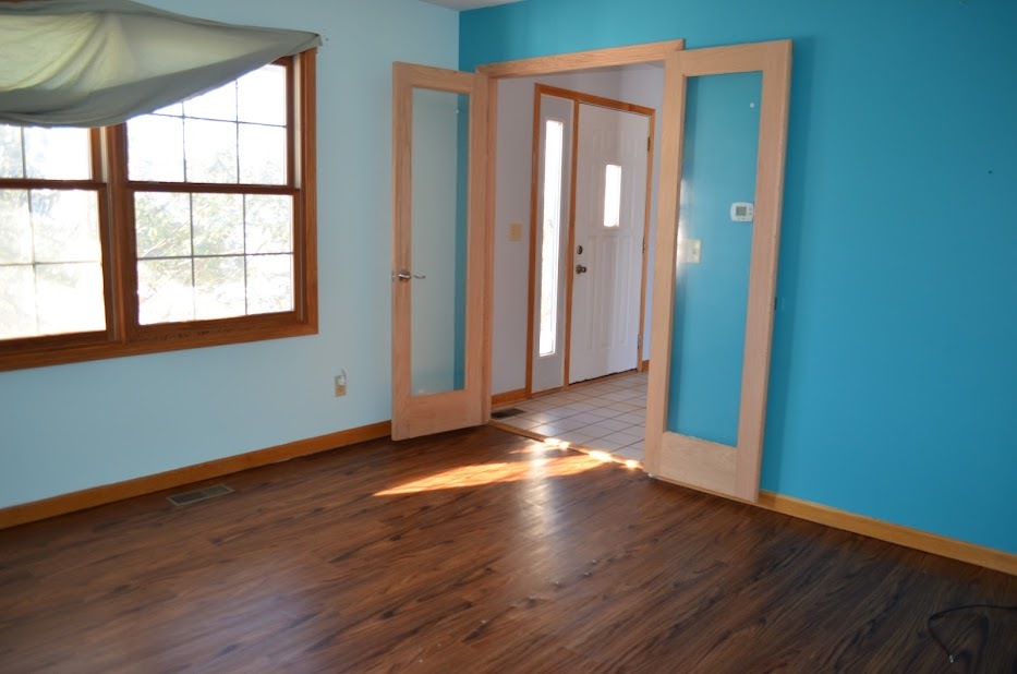 Undisclosed Address Somonauk, IL 60552 - Photo 11 of 25 an empty room with wooden floor and windows
