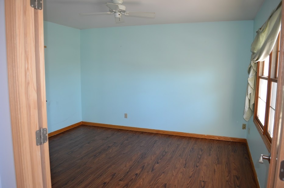 Undisclosed Address Somonauk, IL 60552 - Photo 14 of 25 an empty room with wooden floor and windows