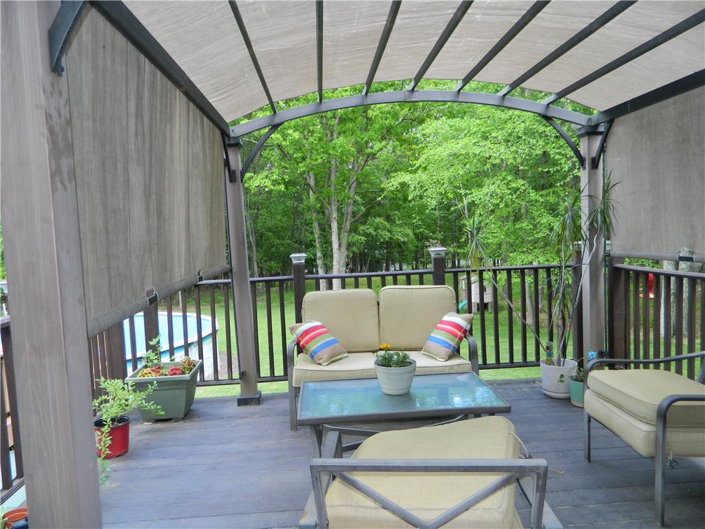 328 Pin Oak Road Stroudsburg, PA 18360 - Photo 5 of 37 An inviting covered patio retreat offers tranquil outdoor living with views of lush greenery.
