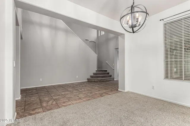 a view of a livingroom with wooden floor and stairs