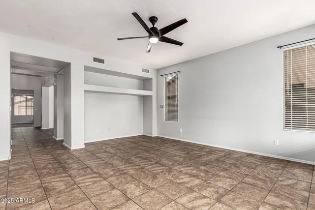 a view of a livingroom with a ceiling fan and window