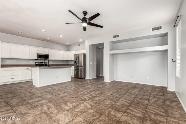 a view of a kitchen with a sink and stainless steel appliances