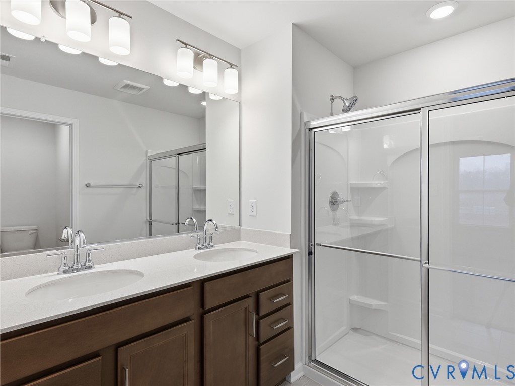 159 Corcoran Way Aylett, VA 23009 - Photo 13 of 20 a bathroom with a double vanity sink mirror and double