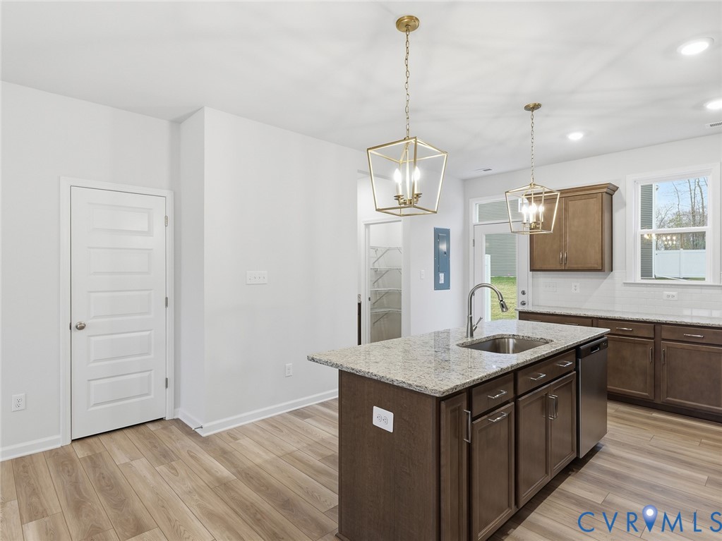 159 Corcoran Way Aylett, VA 23009 - Photo 5 of 20 a kitchen with kitchen island granite countertop stainless steel appliances sink and wooden floor