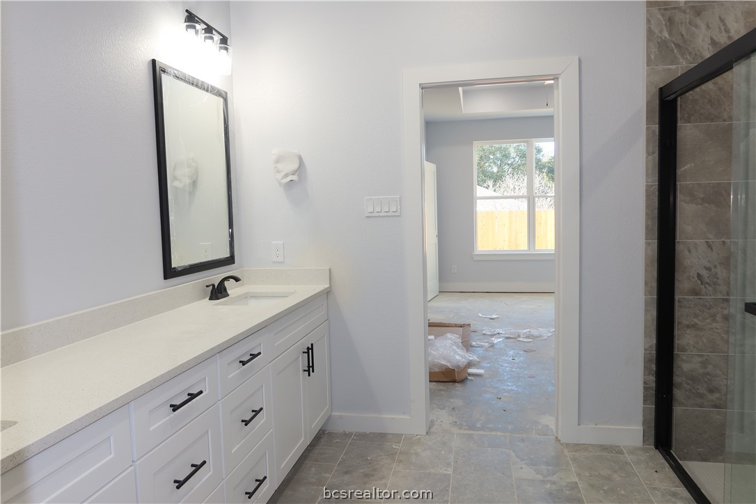 2008 Reagan Court Bryan, TX 77802 - Photo 12 of 21 a bathroom with a double vanity sink and a mirror