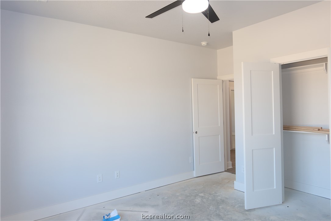 2008 Reagan Court Bryan, TX 77802 - Photo 18 of 21 an empty room with a ceiling fan and a window