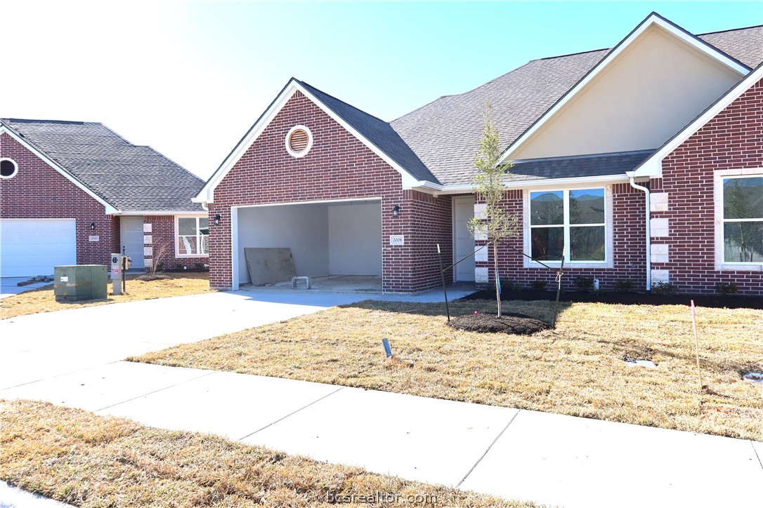 2008 Reagan Court Bryan, TX 77802 - Photo 2 of 21 a front view of a house with a yard