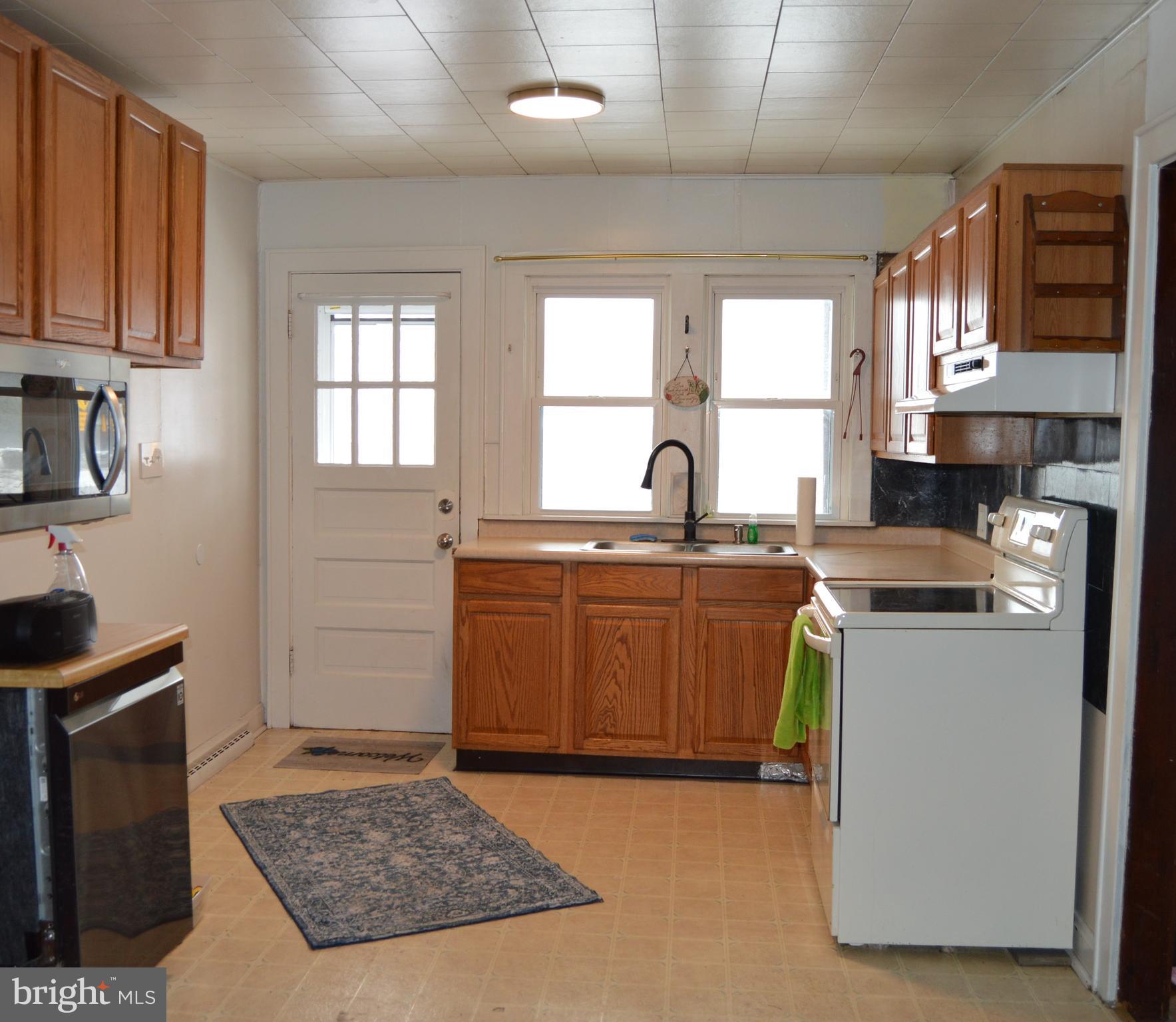 5459 Hutton Road Oakland, MD 21550 - Photo 3 of 40 a kitchen with a sink cabinets and window
