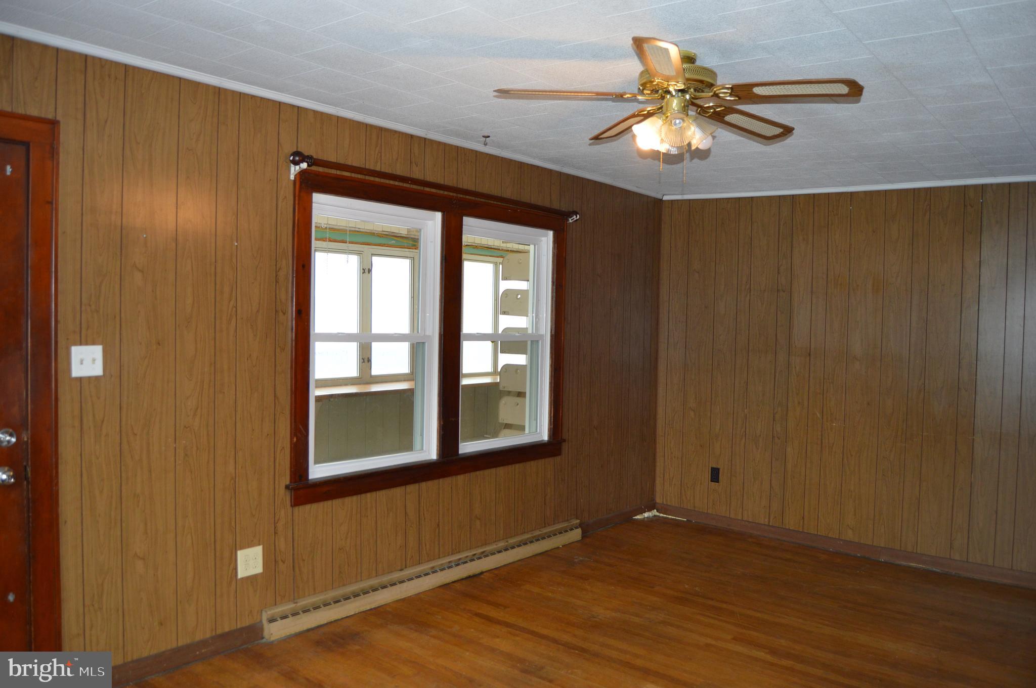5459 Hutton Road Oakland, MD 21550 - Photo 8 of 40 a view of an empty room with window and wooden floor