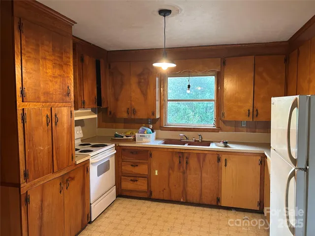 a kitchen with a sink cabinets and stainless steel appliances