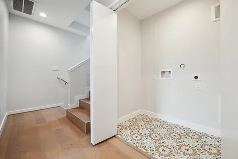 an empty room with closet and windows